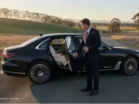 Luxury car with chauffeur outdoors