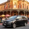 Melbourne heritage sites chauffeur service luxury car arriving at historic building during Australian Heritage Festival