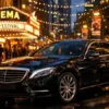 Black Mercedes-Benz first class sedan arriving near a MIFF Film Screenings in Melbourne venue at night