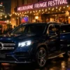Melbourne Fringe Festival Chauffeur Service luxury Mercedes SUV arriving at Melbourne arts festival venue at night