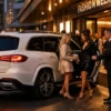 Melbourne Fashion Week Chauffeur Service with a luxury white Mercedes-Benz GLS SUV and professional chauffeur without a hat welcoming guests outside a Melbourne fashion runway venue