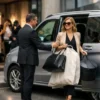 Stylist Chauffeur Melbourne with a luxury silver Mercedes-Benz V-Class and professional chauffeur without a hat assisting a fashion stylist outside a Melbourne photoshoot location