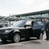 Melbourne airport chauffeur booking checklist with a professional chauffeur beside a black luxury SUV